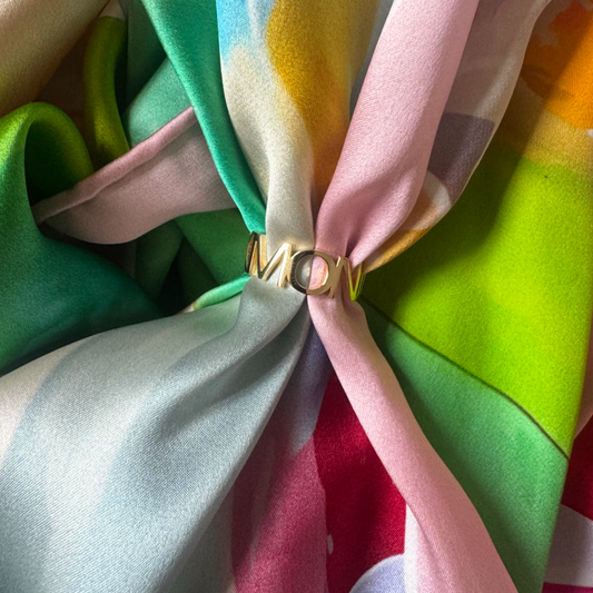 Close-up of colorful fabric with a gold ring in the center